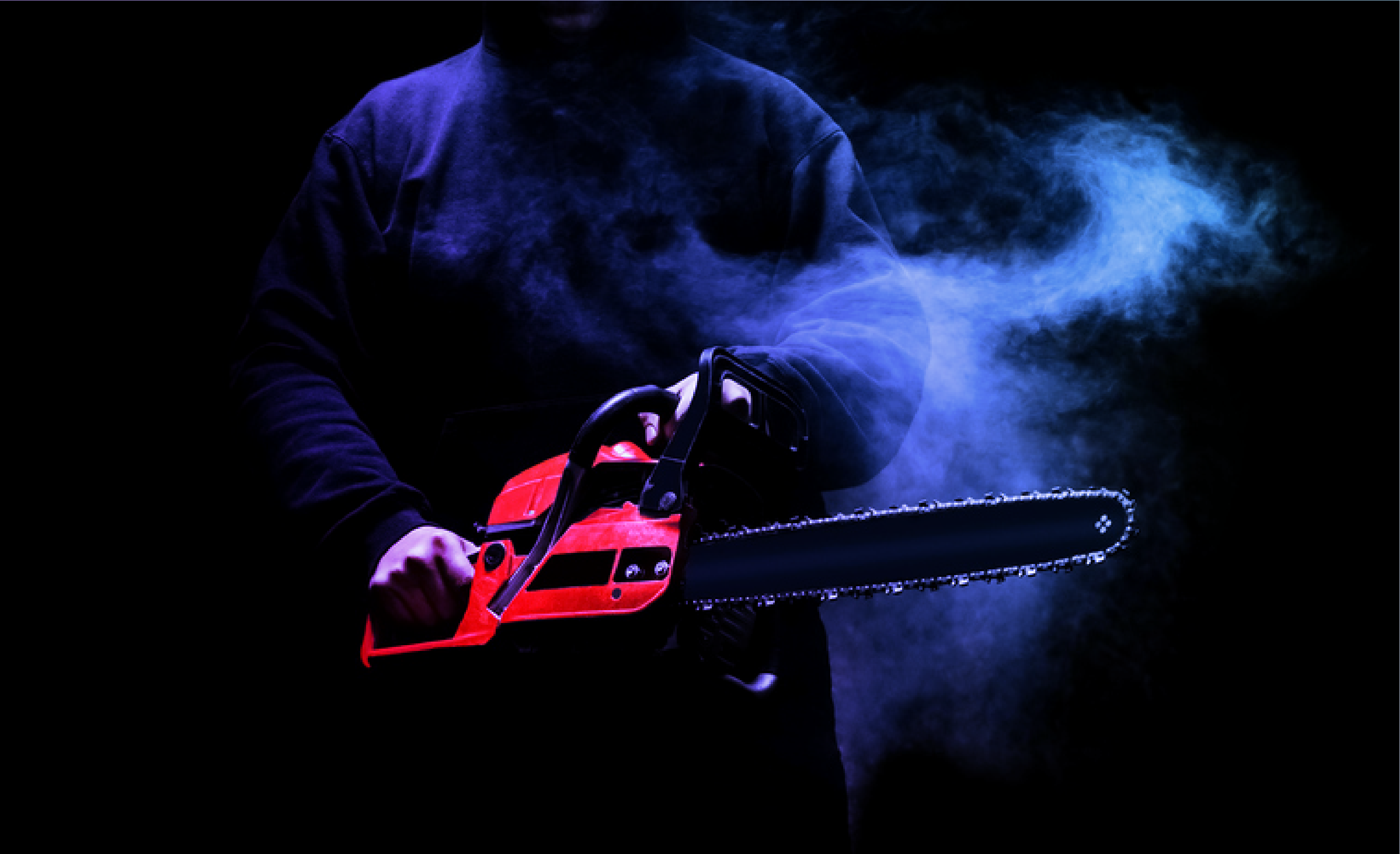 Image of a man holding a chainsaw with smoke around him